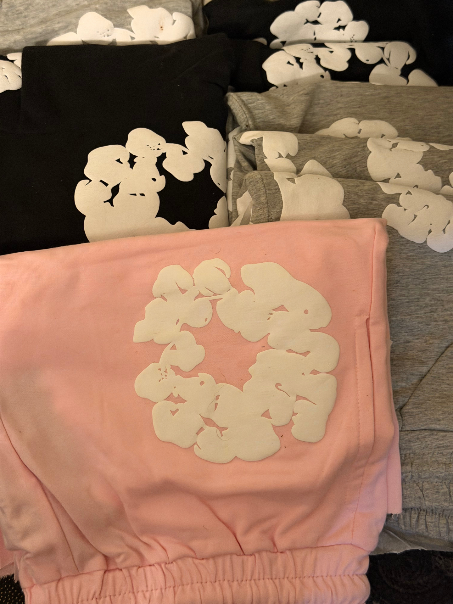 Pink, black and grey designer-style sweat sets from a reseller apparel order