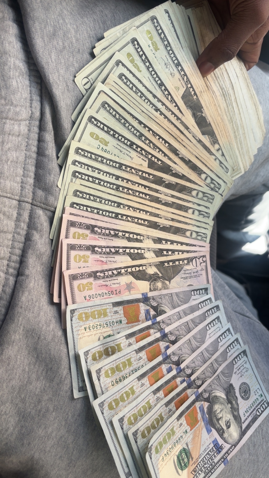 Fanned-out mix of hundred, fifty and twenty-dollar bills from a starter vendor bundle reseller's earnings