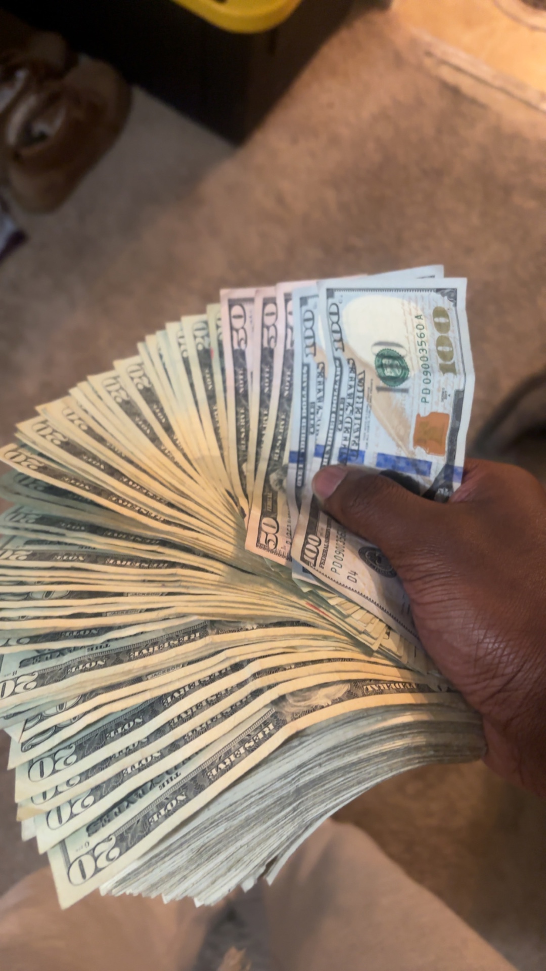 Reseller holding a fanned stack of cash